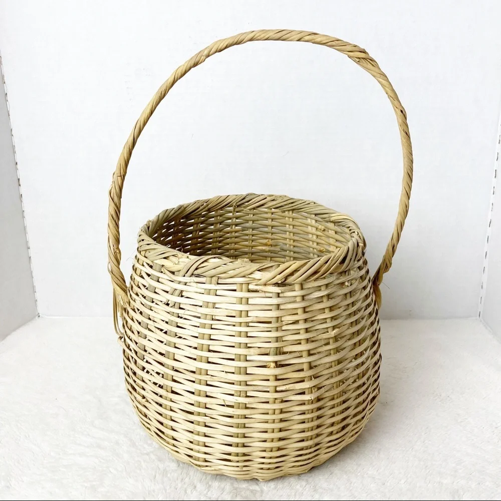 Handwoven deep wicker basket with tall handle